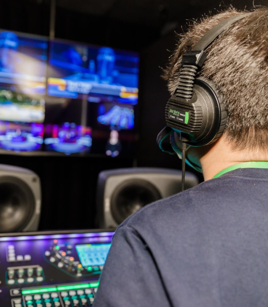 Diverse Team of Engineers with Laptop and a Tablet Analyse and Discuss How a Futuristic Robotic Arm Works and Moves a Metal Object. They are in a High Tech Research Laboratory with Modern Equipment.