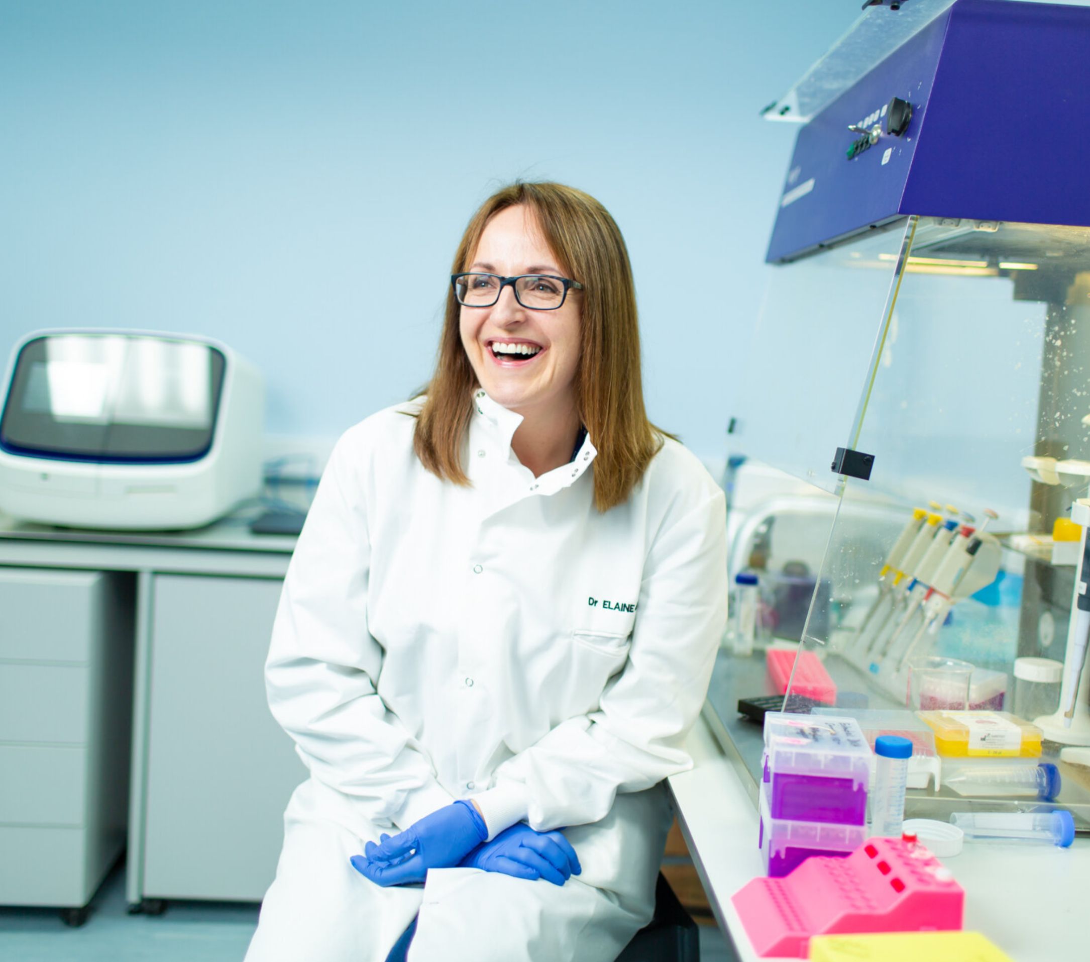 A doctor laughing and smiling in a laboratory