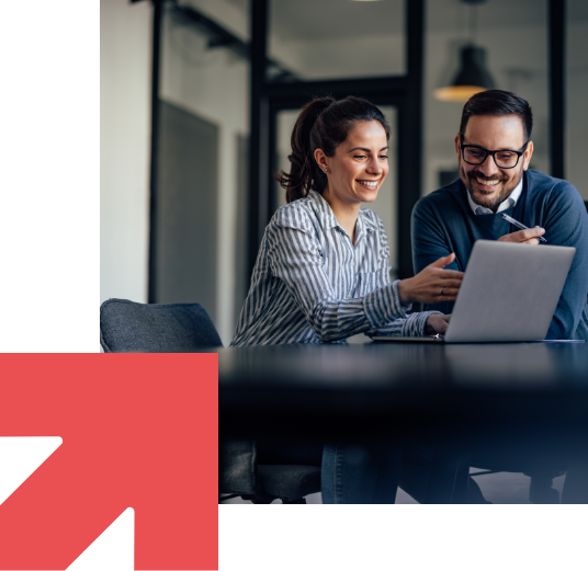 Two team members looking at a laptop screen together