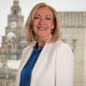 Katherine Fairclough, smiles at the camera with the Royal liver building in the background